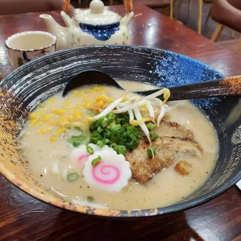 Pork bone ramen with corn, bean sprouts, and a slice of char siu.