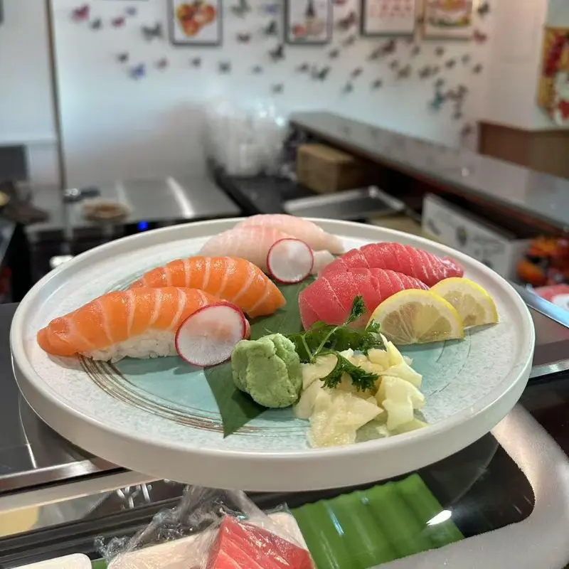 A platter of sashimi and nigiri sushi, including salmon and tuna.
